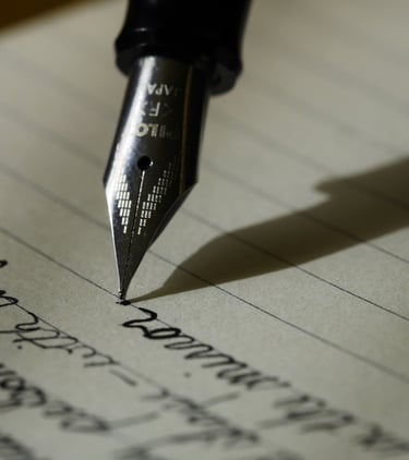 a pen and a fountain pen on a piece of paper