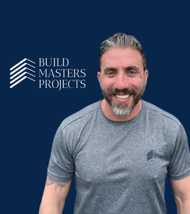 a man with a beard and beard, smiling and wearing a gray shirt