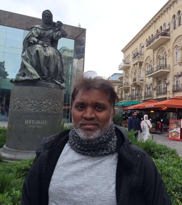 a man standing in front of a statue of a man