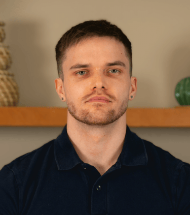 Professional headshot of TJay Harvey, qualified Level 4 sports massage therapist.
