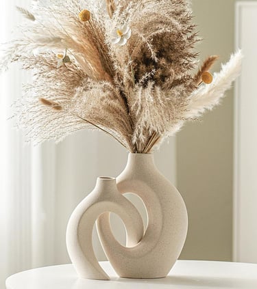 Modern ceramic vase set of 2 styled with dried pampas grass on a table, featuring neutral home decor in minimalist interior.
