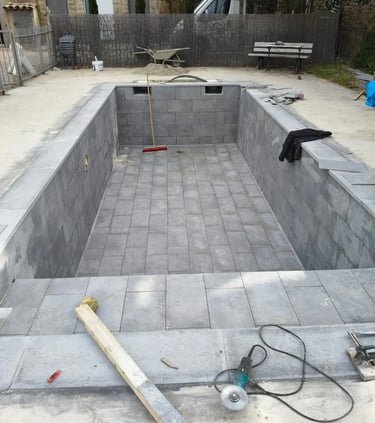 a pool with a concrete pool and a concrete pool