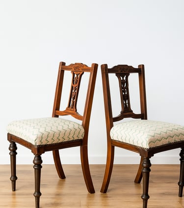 Pair of antique wooden dining chairs with cushioned seats