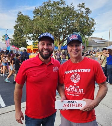 Austin Arthur with firefighter supporter wearing Firefighters for Austin Arthur shirts at a communit