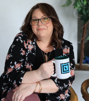 a woman sitting on a chair holding a mug