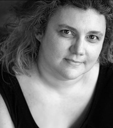 a woman with curly hair and a black top