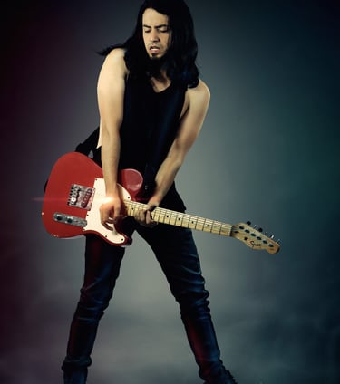 a man with long hair and a guitar