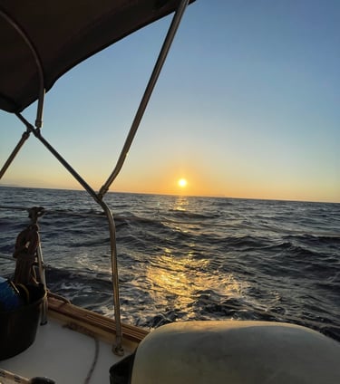 a man sitting on a boat in the ocean