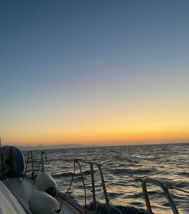 a boat is sailing on the ocean at sunset