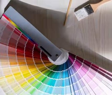 a paint swatch fan opened up showing colors ranging from reds to yellows