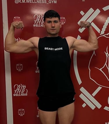 a fitness man in a black tank top and shorts