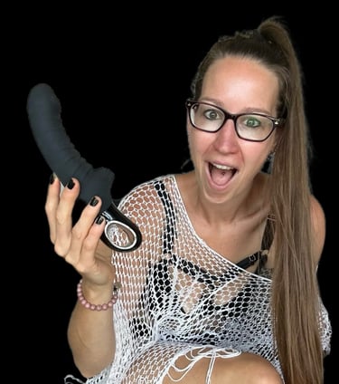 Pleasurelit Patricia holding the black Tiger Vibrator from Fun Factory.