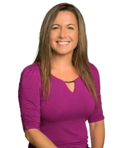 a white woman in a purple shirt smiling