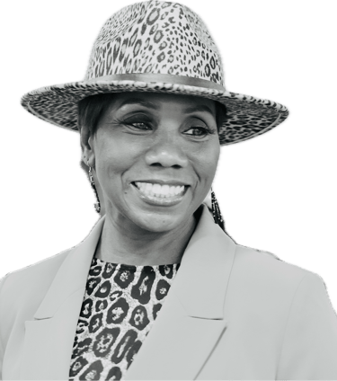 Smiling woman wearing a leopard print fedora hat and matching blouse with a stylish blazer.