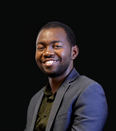 Smiling professional Black man in a grey suit jacket posing for a business headshot.