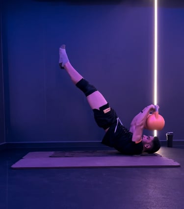 A man doing a dragon flag with bells. Calisthenics.