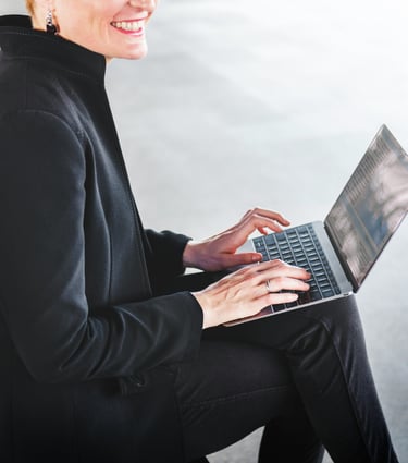 Modern businesswoman typing on a laptop