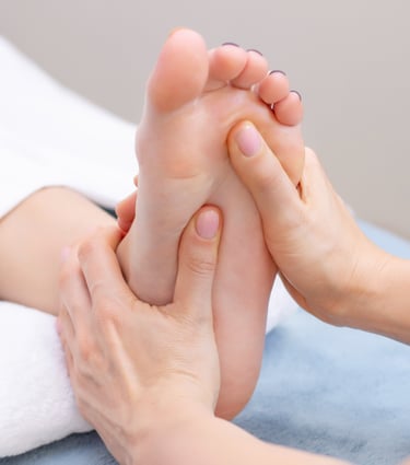 a person is getting their foot massaged