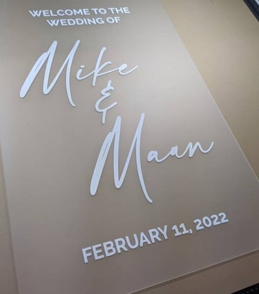 Acrylic wedding welcome sign for Mike and Maan dated February 11, 2022, displayed on a printing bed.