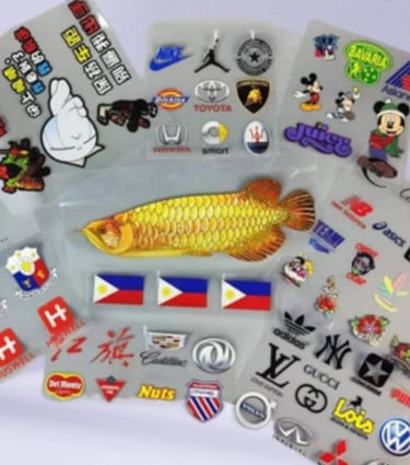 Assorted collection of UV DTF printed brand stickers on a transparent sheet.