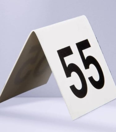 White Acrylic Table Tent with a number 55