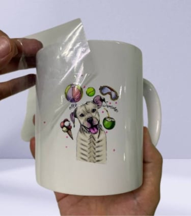 UV DTF sticker being applied to a white ceramic mug with a dog design.