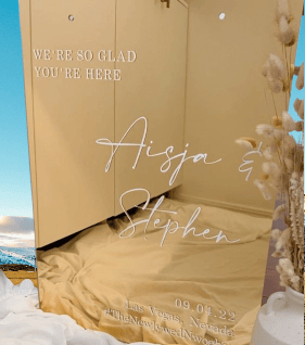 Elegant gold acrylic wedding sign with names Aisja & Stephen.