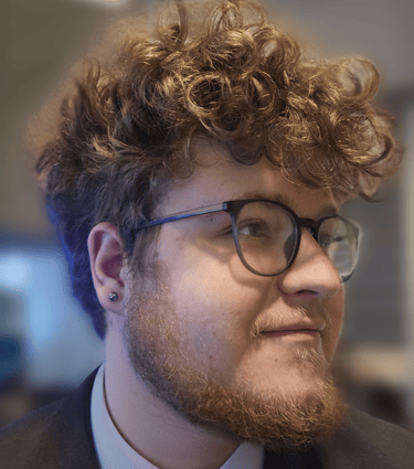 a man with a beard and glasses on his head