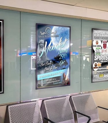 Nightclub event poster displayed at a bus station in large format.