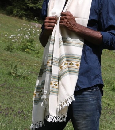 a man  standing in the grass with Vasanth shawl