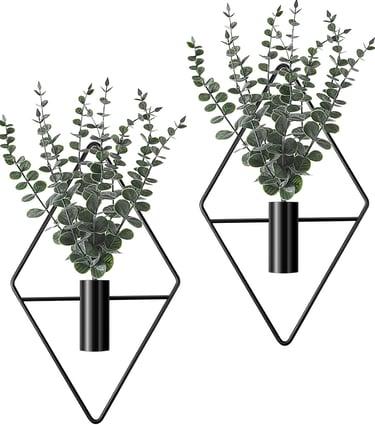 Set of two wall-mounted black diamond geometric planters with artificial eucalyptus greenery for modern home decor.