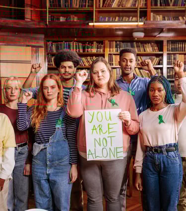 a group of people standing with the words you are not alone written on paper
