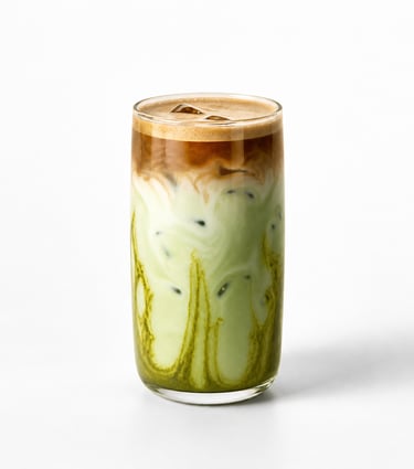 Iced dirty matcha latte with espresso shot and green tea swirls in a tall glass.