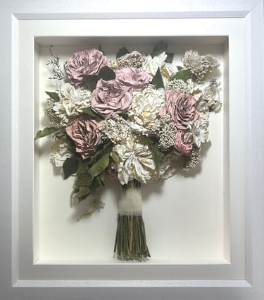 a pink and white side view preserved wedding bouquet in a frame