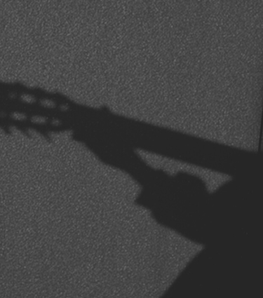 Silueta de una guitarra clásica de seis cuerdas en blanco y negro.