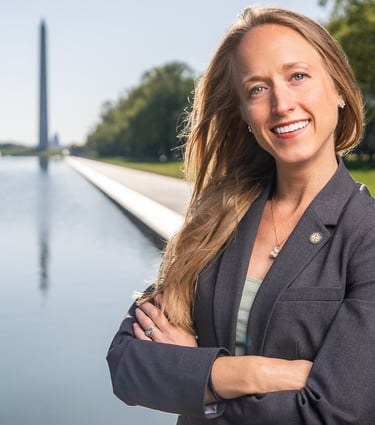 a woman in a suit and tie smiling