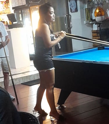Thai woman playing pool at bar on Soi 94 in Hua Hin