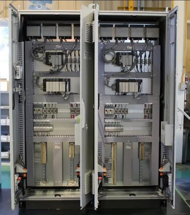 Industrial electrical control panel with organized PLC modules and wiring for automated systems.