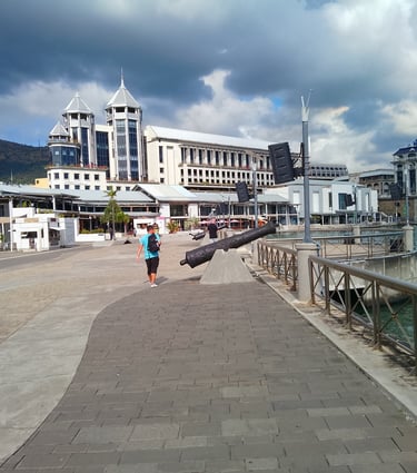 a man walking down a path with a large black object