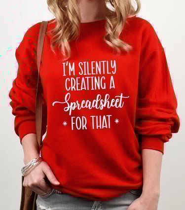 A woman in a red sweatshirt with white stylized letters reading "I'm silently creating a Spreadsheet for that"