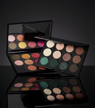 Two professional matte and shimmer eyeshadow palettes featuring neutral and bold pigments on a reflective surface.