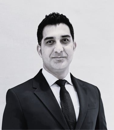 Black and white photo of a professional man wearing suit blue pen education consulting