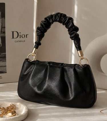 Ruched black bag with luxury background.