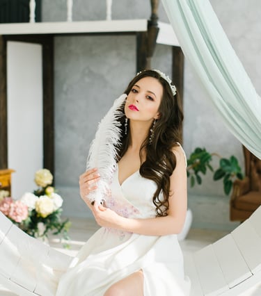 a woman in a white dress sitting on a circular object