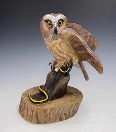 a bird perched on a tree stump
