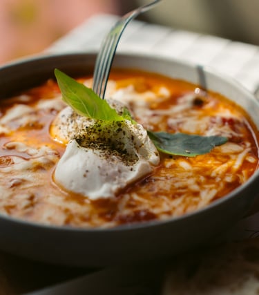 a bowl of soup with a fork and a fork