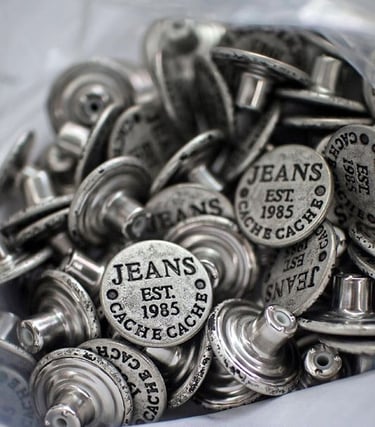 Metal buttons, zipper pulls, and clothing hardware with custom branding