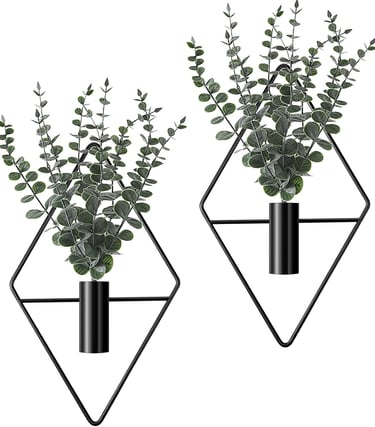 Set of two wall-mounted black diamond geometric planters with artificial eucalyptus greenery for modern home decor.