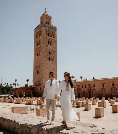 a bride and groom walking through a stone wall