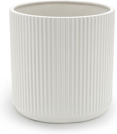 a white ceramic vase with a white ribbed